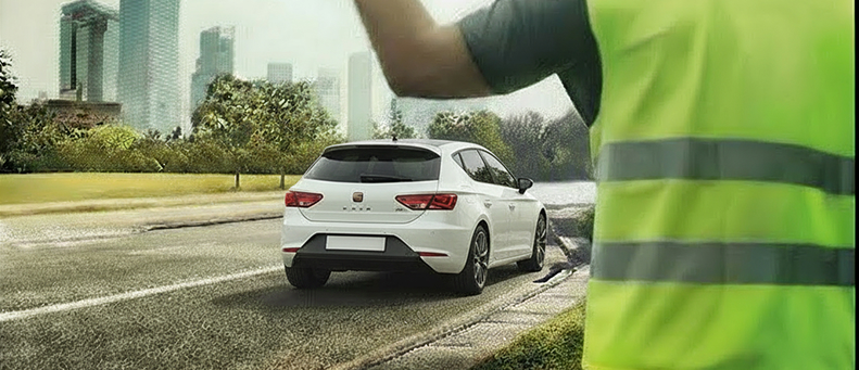 Roadside technician fitting a new car battery to a Cupra