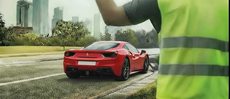 Roadside technician fitting a new car battery to a Ferrari