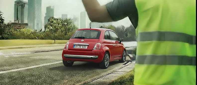 Roadside technician fitting a new car battery to a Fiat